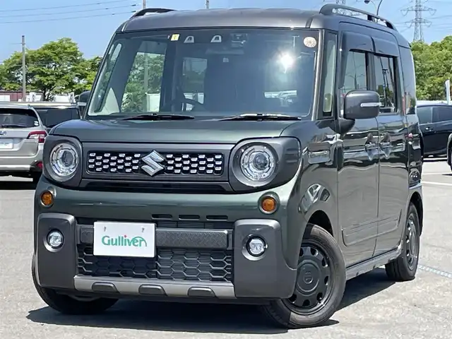 スズキ スペーシア ギア HYBRID XZターボ 道央・札幌 2021(令3)年 0.1万km未満 クールカーキパールメタリック/ガンメタリック2トーン ４WD/ワンオーナー/社外メモリーナビ/CD/DVD/BT/フルセグ/衝突被害軽減ブレーキ/横滑り防止装置/レーダークルーズコントロール/レーンキープアシスト/リヤパーキングセンサー/バックカメラ/ビルトインETC2.0/ドライブレコーダー/アイドリングストップ/両側パワースライドドア/前席シートヒーター/シートカバー/革巻きステアリング/ステアリングリモコン/パドルシフト/AC100V/プッシュスタート/スマートキー/LEDヘッドライト/h粗衣オートライト/オートハイビーム/フォグランプ/電動格納ミラー/ヒーテッドドアミラー/ウィンカーミラー/純正フロアマット/ドアバイザー