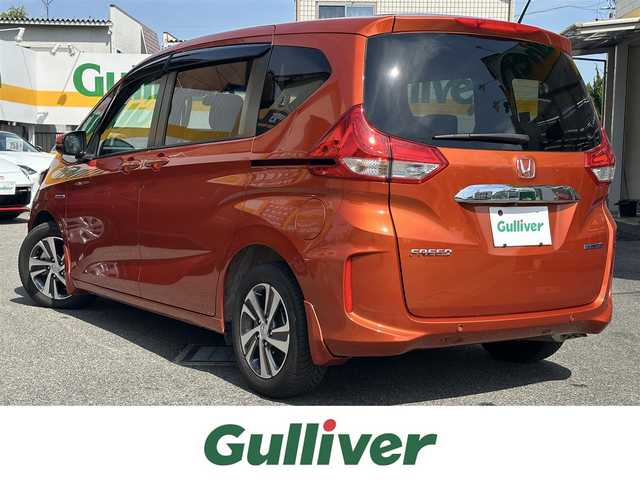 ホンダ フリード ハイブリット G ホンダセンシング 三重県 2021(令3)年 4.8万km プレミアムクリスタルオレンジM ホンダセンシング/純正ナビ/　・フルセグＴＶ/　・Bluetooth/　・ＤＶＤ再生/　・ＵＳＢ/　・録音/バックガイドカメラ/アダプティブクルーズコントロール/両側パワースライドドア/スマートキーｘ２/プッシュスタート/ハーフレザーシート/D/N席シートヒーター/ＬＥＤヘッドライト/ドライブレコーダー（前後）/ステアリングスイッチ/オートリトラクタブルミラー/ターンミラー/純正フロアマット/プライバシーガラス/横滑り防止機能