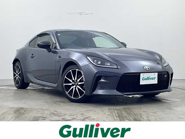 トヨタ ＧＲ８６ SZ 秋田県 2022(令4)年 0.8万km マグネタイトグレーメタリック 6MT/社外メモリナビ/　（Bluetooth/TV/HDMI）/バックカメラ/革巻きハンドル/クルーズコントロール/ステアリングスイッチ/ETC/プッシュスタート/前後ドライブレコーダー/社外フロアマット/純正17インチアルミホイール/LEDヘッドライト/オートライト/社外マフラー（ロッソモデロ）/ドアバイザー/スマートキー/スペアキー