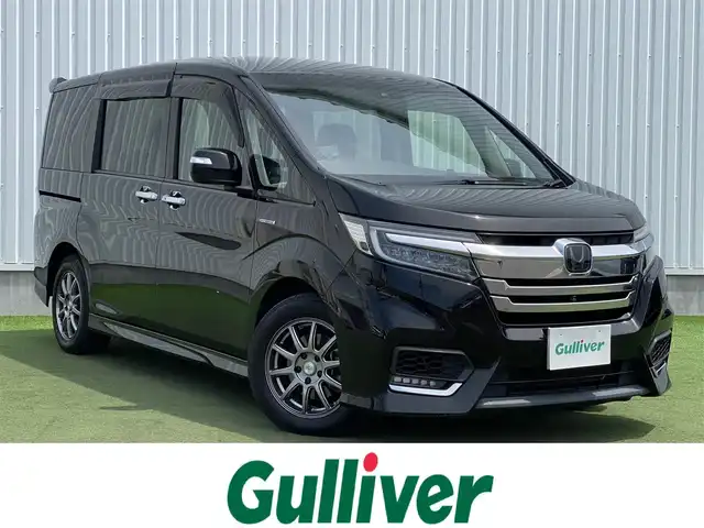 ホンダ ステップワゴン スパーダ ハイブリッド G EX ホンダセンシング 香川県 2018(平30)年 9.7万km プレミアムスパークルブラックパール 登録時走行距離：96394km/純正10型ナビ/　CD DVD BT　フルセグTV/純正11.6型フリップダウンモニター/全方位カメラ/両側パワースライドドア/ホンダセンシング/レーダークルーズコントロール/レーンキープアシスト/LEDヘッドライト/オートライト/フォグランプ/横滑り防止装置/ビルトインETC/ハーフレザーシート/シートヒーター/革巻きステアリング/ステアリングスイッチ/プッシュスタート/スマートキー/スペアキー