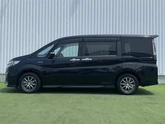 ホンダ ステップワゴン スパーダ ハイブリッド G EX ホンダセンシング 香川県 2018(平30)年 9.7万km プレミアムスパークルブラックパール 登録時走行距離：96394km/純正10型ナビ/　CD DVD BT　フルセグTV/純正11.6型フリップダウンモニター/全方位カメラ/両側パワースライドドア/ホンダセンシング/レーダークルーズコントロール/レーンキープアシスト/LEDヘッドライト/オートライト/フォグランプ/横滑り防止装置/ビルトインETC/ハーフレザーシート/シートヒーター/革巻きステアリング/ステアリングスイッチ/プッシュスタート/スマートキー/スペアキー