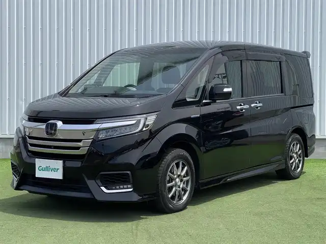 ホンダ ステップワゴン スパーダ ハイブリッド G EX ホンダセンシング 香川県 2018(平30)年 9.7万km プレミアムスパークルブラックパール 登録時走行距離：96394km/純正10型ナビ/　CD DVD BT　フルセグTV/純正11.6型フリップダウンモニター/全方位カメラ/両側パワースライドドア/ホンダセンシング/レーダークルーズコントロール/レーンキープアシスト/LEDヘッドライト/オートライト/フォグランプ/横滑り防止装置/ビルトインETC/ハーフレザーシート/シートヒーター/革巻きステアリング/ステアリングスイッチ/プッシュスタート/スマートキー/スペアキー