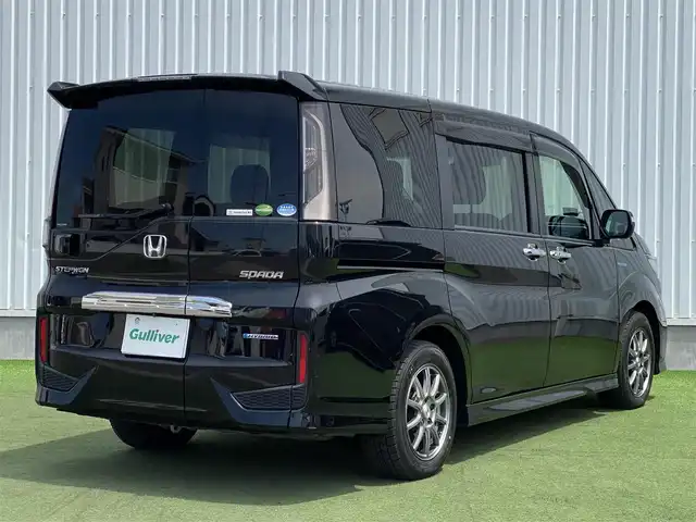 ホンダ ステップワゴン スパーダ ハイブリッド G EX ホンダセンシング 香川県 2018(平30)年 9.7万km プレミアムスパークルブラックパール 登録時走行距離：96394km/純正10型ナビ/　CD DVD BT　フルセグTV/純正11.6型フリップダウンモニター/全方位カメラ/両側パワースライドドア/ホンダセンシング/レーダークルーズコントロール/レーンキープアシスト/LEDヘッドライト/オートライト/フォグランプ/横滑り防止装置/ビルトインETC/ハーフレザーシート/シートヒーター/革巻きステアリング/ステアリングスイッチ/プッシュスタート/スマートキー/スペアキー