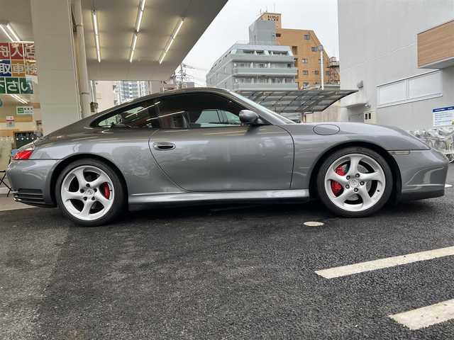 ポルシェ ９１１ カレラ4 S 広島県 2003(平15)年 5.5万km シールグレー 走行距離54575km（入庫時）/　社外ディスプレイオーディオ/　純正18インチアルミホイール/　本革シート（赤色）/　フロントパワーシート（運転席：メモリ付き）/　フロントシートヒーター/　ティプトロニック/　ETC/　ルーフ：アルカンターラ（内）/　バックカメラ/　キーレスキー/○タイヤサイズ/・フロント：225/40/18/・リア：295/30/18