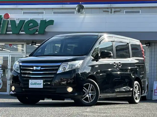 トヨタ ノア ハイブリッド G 愛知県 2015(平27)年 14.2万km ブラック /禁煙//アルパイン12.8インチフリップダウンモニター//アルパイン10インチナビ//CD/DVD/BT/MSV/フルセグ//バックカメラ//レーダー探知機//置くだけ充電//純正ドライブレコーダー//ビルトインETC//両側パワースライドドア//PCS//クルーズコントロール//横滑り防止装置//シートヒーター//LEDオートライト//フォグランプ//オートリトラウィンカーミラー//ロールサンシェード//革巻きステアリング//ステアリングスイッチ//照明付バニティミラー//nanoe//純正フロアマット//純正ドアバイザー//スペアスマートキー//新車時保証書//取扱説明書//サマータイヤ付純正15AW積込