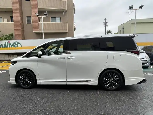 トヨタ ヴェルファイア Z プレミア 静岡県 2025(令7)年 0.1千km プラチナホワイトパールマイカ 登録時走行29km/ワンオーナー/モデリスタエアロ/左右独立ムーンルーフ/ユニバーサルステップ/寒冷地仕様/純正ナビ/フルセグTV/BT/USB/全方位カメラ/デジタルインナーミラー/黒革シート/両側パワースライドドア/パワーバックドア/シートヒーター/エアシート/置くだけ充電/プリクラッシュセーフティ/レーンディパーチャーアラート/レーダークルーズコントロール/オートハイビーム/ブラインドスポットモニター/クリアランスソナー/ヘッドアップディスプレイ/プロアクティブドライビングアシスト/ビルトインETC2.0/ステアリングヒーター/スマートキー×2/保証書/取扱説明書