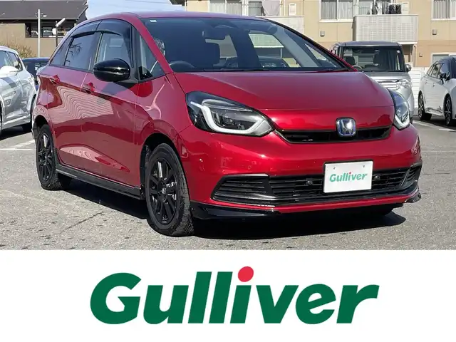 ホンダ フィット e:HEVホーム ブラックスタイル 群馬県 2024(令6)年 0.9万km プレミアムクリスタルレッドM ワンオーナー/純正ディスプレイオーディオ/バックカメラ/ホンダセンシング/ＬＥＤヘッドライト/純正ドライブレコーダー前後カメラ/ステアリングリモコン/スマートキー/保証書/取説/スペアキーｘ１