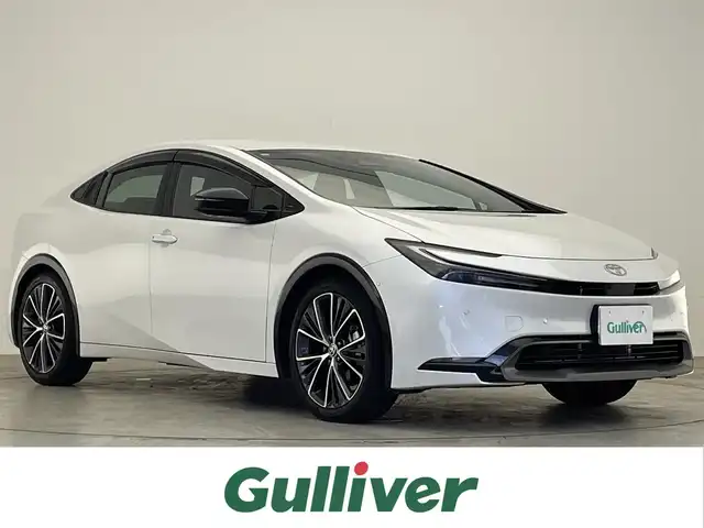 トヨタ プリウス Z 滋賀県 2024(令6)年 1万km プラチナホワイトパールマイカ 禁煙車/純正12.3型ディスプレイオーディオ/全周囲カメラ/AM/FM/Bluetooth/Miracast/フルセグTV/シートヒーター/エアーシート/ステアリングヒーター/パワーシート/LEDヘッドライト/オートライト/デジタルインナーミラー/ブラインドスポットモニター（BSM）/安全降車アシスト（SEA）＋ドアオープン制御（e-latch）/パーキングサポートブレーキ（前後方・静止物・車両）/アドバンスト パーク（高度自動駐車）/プリクラッシュセーフティ（PCS）/レーントレーシングアシスト（LTA）/レーンディパーチャーアラート（LDA）/レーダークルーズコントロール（全車速追従機能付）/オートマチックハイビーム（AHB）/ロードサインアシスト（RSA）/プロアクティブドライビングアシスト（PDA）/AC100V/純正アルミホイール