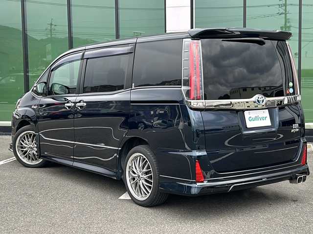 トヨタ ノア ハイブリッド Si ダブルバイビー 愛媛県 2018(平30)年 5.3万km ブラッキッシュアゲハガラスフレーク 外部検査実施済み/ワンオーナー/モデリスタエアロ/純正SDナビ【NSZN-Z61T】/(DVD/フルセグTV/Bluetooth/USB/MSV)/バックカメラ/フリップダウンモニター/両側パワースライドドア/TOYOTA Safety Sense/・レーダークルーズ コントロール/・プリクラッシュセーフティ/・レーントレーシングアシスト/・レーンディパーチャーアラート/・ロードサインアシスト/・先行車発進告知機能/・オートマチックハイビーム/前方ドライブレコーダー/ハーフレザーシート/前席シートヒーター/横滑り防止機能/スマートキー2個/プッシュスタート/LEDヘッドライト/ビルトインETC/新車時保証書/取扱説明書