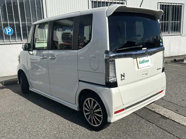 ホンダ Ｎ ＢＯＸ カスタム G ターボ Lパッケージ 富山県 2015(平27)年 14.2万km プレミアムホワイトパールⅡ ワンオーナー/両側パースライドドア/スマートキー×２/社外メモリーナビ(AIC-ZH0999L)/DVD/MSV/BT/デジタルTV/ETC/純正フルエアロ/皮巻きステアリング/ステアリングスイッチ/オートリトラミラー/パドルシフト/横滑り防止装置/電格ウィンカーミラー/クルーズコントロール/プッシュスタート/HIDヘッドライト/フォグ/リアロールシェイド/電格ウィーンカーミラ―/保証書・取説