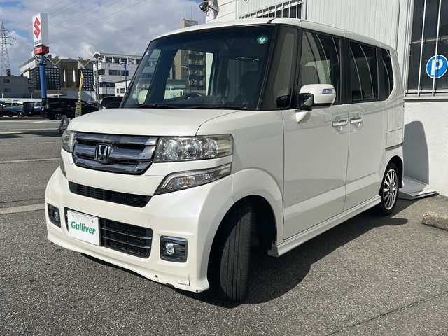 ホンダ Ｎ ＢＯＸ カスタム G ターボ Lパッケージ 富山県 2015(平27)年 14.2万km プレミアムホワイトパールⅡ ワンオーナー/両側パースライドドア/スマートキー×２/社外メモリーナビ(AIC-ZH0999L)/DVD/MSV/BT/デジタルTV/ETC/純正フルエアロ/皮巻きステアリング/ステアリングスイッチ/オートリトラミラー/パドルシフト/横滑り防止装置/電格ウィンカーミラー/クルーズコントロール/プッシュスタート/HIDヘッドライト/フォグ/リアロールシェイド/電格ウィーンカーミラ―/保証書・取説