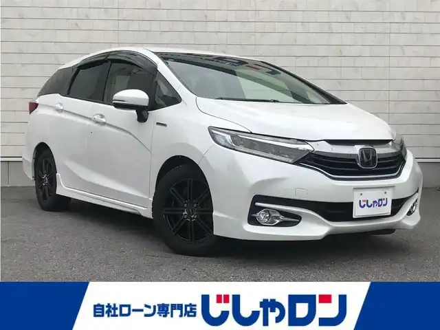 ホンダ シャトル ハイブリッド X ホンダセンシング 栃木県 2017(平29)年 8.9万km ホワイトオーキッドパール 株)IDOMが運営する【じしゃロン小山店】の自社ローン専用車両になります。こちらは現金またはオートローンご利用時の価格です。自社ローンご希望の方は別途その旨お申付け下さい//禁煙車/社外フルセグナビ/（CD/DVD/AM/FMラジオ）/(Bluetooth)/スマートキー/プッシュスタート/バックカメラ/クルーズコントロール/レーンキープアシスト/衝突軽減システム/シートヒーター/先行車発進告知/ステアリングリモコン/電動格納ドアミラー/パワーウインドウ/防眩ミラー/オートライト