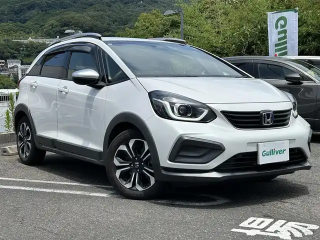 ホンダ フィット e:HEVクロスター 長崎県 2020(令2)年 4.6万km プラチナホワイトパール 純正HDDナビ(BT/FM/AM/フルセグ/CD/DVD)/プッシュスタート/スマートキー/スペアキー(1本)/渋滞追従機能付アダプティブクルーズコントロール/ナビ連動型ドラレコ/ビルトインETC/ステアリングスイッチ/純正フロアマット/純正16インチアルミホイール/ABS/VSA/LKAS/踏み間違い衝突軽減システム/CMBS/オートライト/パーキングセンサーシステム/SRSダブル・サイドエアバッグ/SRSカーテンエアバッグ/ISOFIX/イモビライザーシステム/取扱説明書/保証書/記録簿