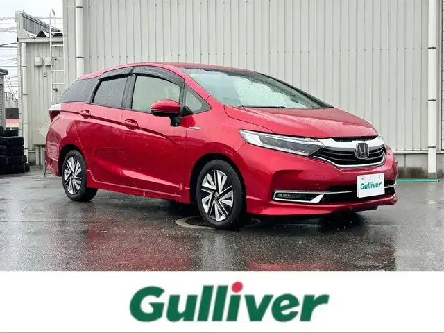 ホンダ シャトル ハイブリッド X ホンダセンシング 富山県 2020(令2)年 5.6万km プレミアムクリスタルレッドM ワンオーナー/純正SDナビ/(AM/FM/CD/DVD/BT/USB/ipod)/フルセグTV/バックカメラ/レーダークルーズコントロール/コーナーセンサー/衝突軽減システム/レーンキープアシスト/横滑り防止装置/盗難防止装置/パドルシフト/ビルトインETC/シートヒーター　運転席＋助手席/ハーフレザーシート/フロアマット社外/LEDライト/フォグランプ/カーテンエアバッグ/スマートキー×2/取扱説明書/保証書