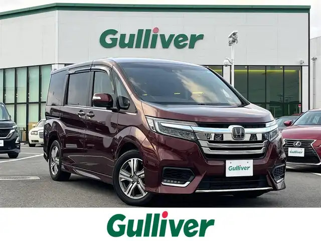 ホンダ ステップワゴン スパーダ ホンダセンシング 愛媛県 2017(平29)年 8.4万km プレミアムディープロッソパール 社外ナビ/BT/AM・FM/CD/DVD/フルセグTV/２列目リアモニター/ETC/ホンダセンシング/バックカメラ/追従型クルーズコントロール/レーンキープアシスト/両側パワースライドドア/アイドリングストップ/３列シート/オートライト/リモコンエンジンスターター/ステアリングスイッチ/ハンズフリー/純正アルミホイール/社外フロアマット