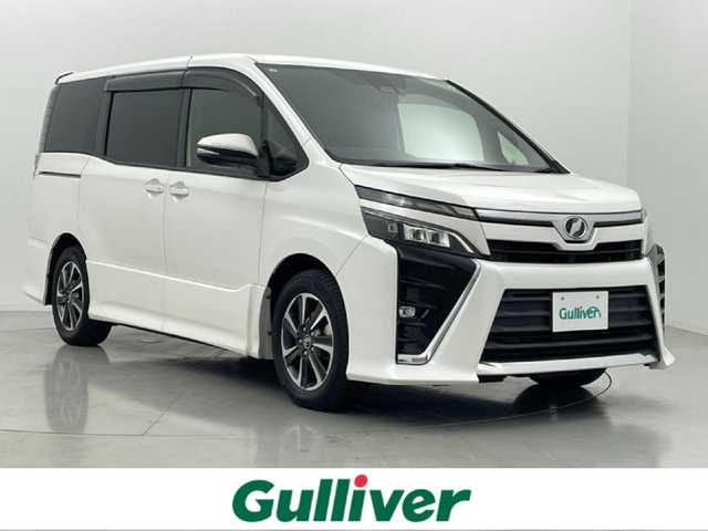 トヨタ ヴォクシー ZS 熊本県 2017(平29)年 1.8万km ホワイトパールクリスタルシャイン 純正10インチナビNSZT-Z66T（ＣＤ・ＤＶＤ・フルセグ・ＢＴ・ＳＤ）/バックカメラ　/純正前方ドライブレコーダー　/純正12.1インチフリップダウンモニター/ビルトインＥＴＣ　/両側パワースライドドア　/アイドリングストップ　/トヨタセーフティーセンス/・プリクラッシュセーフティ/・レーンディパーチャーアラート/・オートマチックハイビーム/・クルーズコントロール/横滑り防止/純正フロアマット/純正１６インチAW/オートライト/LEDヘッドライト/スマートキー/プッシュスタート/スペアキー1本/保証書