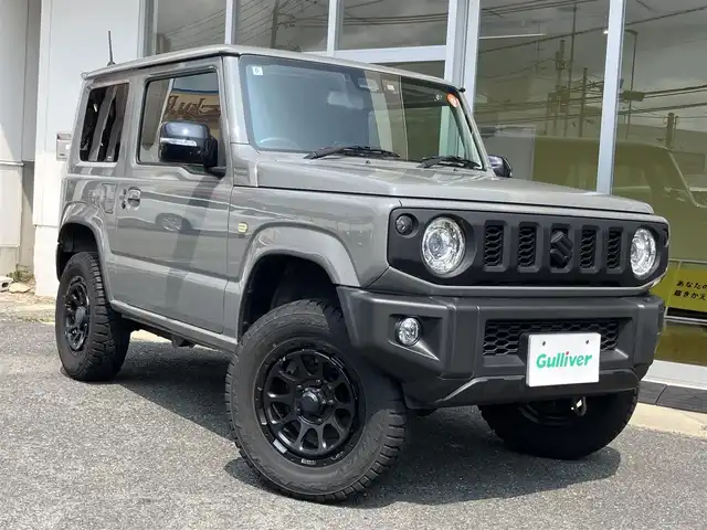 スズキ ジムニー XC 山口県 2022(令4)年 1万km ミディアムグレー 1inリフトアップ(バネ)/社外ディスプレイオーディオ/　＆バックカメラ/社外16インチアルミ/デュアルセンサーブレーキサポート/純正フロアマット/純正フォグランプ/ウィンカーミラー/スマートキー/エンジンプッシュスタート/オートライト/フロントシートヒーター/ETC