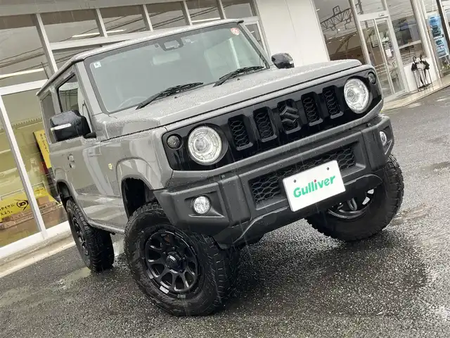 スズキ ジムニー XC 山口県 2022(令4)年 1万km ミディアムグレー 1inリフトアップ(バネ)/社外ディスプレイオーディオ/　＆バックカメラ/社外16インチアルミ/デュアルセンサーブレーキサポート/純正フロアマット/純正フォグランプ/ウィンカーミラー/スマートキー/エンジンプッシュスタート/オートライト/フロントシートヒーター/ETC