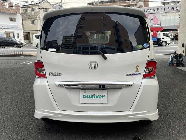 ホンダ フリード ハイブリット プレミアムエディション 大阪府 2016(平28)年 1.9万km ホワイトオーキッドパール ワンオーナー/純正メモリーナビ/フルセグTV/Bluetooth/DVD/純正フリップダウンモニター/バックカメラ/両側パワースライドドア/スマートキー/純正キセノンライト/ビルトインETC