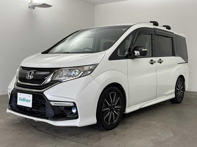 ホンダ ステップワゴン モデューロX 兵庫県 2017(平29)年 10.5万km ホワイトオーキッドパール ・純正9インチナビ（フルセグ・BT・SD・DVD）/・バックカメラ/・両側パワースライドドア/・ETC/・純正ドライブレコーダー/・パドルシフト/・ステアリングリモコン/・LEDオートライト/・フォグランプ/・レーンキープアシスト/・レーダークルーズコントロール/・衝突軽減ブレーキ/・車線逸脱警報/・純正フリップダウンモニター/・横滑り防止装置/・ロールサンシェード/・純正17インチアルミホイール（モデューロ）/・モデューロ専用ブラックコンビシート/・純正フロアマット/・ドアバイザー/・アイドリングストップ/・W＋サイドエアバック/・カーテンエアバック/・スマートキー/・スペアキー/・プッシュスタート/・ECON/・電動格納ミラー