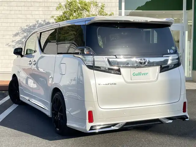 トヨタ ヴェルファイア Z Gエディション 愛媛県 2015(平27)年 3.6万km ホワイトパールクリスタルシャイン 純正９型ナビ　/モデリスタフルエアロ　/後席モニター　/Ｂカメラ　/クルコン　/障害物センサー　/純正前後ドラレコ　/ビルトインＥＴＣ　/Ｗエアコン　/両側電動スライドドア　/パワーシート　/ハーフレザー　/MTモード付き