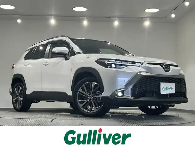 トヨタ カローラ クロス ハイブリッド Z 愛知県 2024(令6)年 0.6万km プラチナホワイトパールマイカ 純正９インチナビ　/(FM/AM/Bluetooth/フルセグTV/AppleCarPlay/AndoroidAuto)/パノラマルーフ　/ブラインドスポットモニター　/トヨタセーフティセンス　/　　-プリクラッシュセーフティ/　　-レーントレーニングアシスト＋レーンディパーチャーアラート/　　-レーダークルーズコントロール/　　-オートマチックハイビーム/　　-ロードサインアシスト/　　-発進遅れ告知機能/ビルトインＥＴＣ２．０　/シートヒーター　/ＬＥＤヘッドライト　/バックカメラ　/電動リアゲード/D席パワーシート　/純正フロアマット　/半革シート　/フォグランプ/プッシュスタート/　　-スマートキー