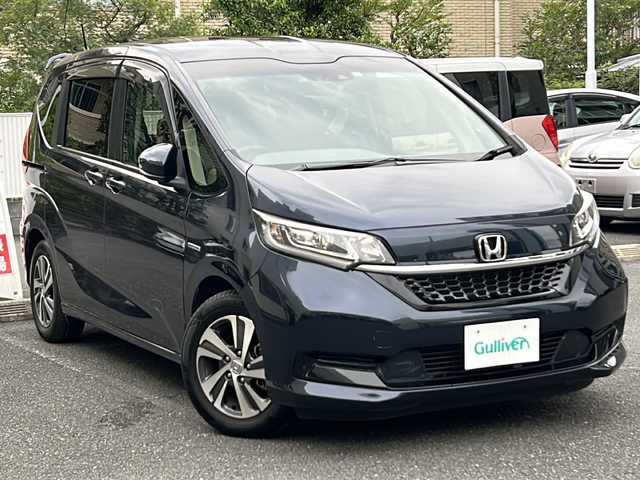 ホンダ フリード ハイブリット G ホンダセンシング 埼玉県 2020(令2)年 4.3万km ミッドナイトブルービームM 登録時４２３４５ｋｍ/ワンオーナー/純正SDナビ(フルセグ)/BT/CD/DVD/両側パワースライドドア/衝突被害軽減装置/横滑り防止装置/レーダークルーズコントロール/レーンキープアシスト/バックセンサー/ナビ連動型純正前後ドライブレコーダー/ナビ連動型ETC/バックカメラ/純正１５インチアルミホイール/ステアリングリモコン/シートヒーター（D＋N）/プラズマクラスター搭載エアコン/LEDヘッドライト/フォグランプ/ヒーテッドミラー/プッシュスタート/スマートキー/保証書/取扱説明書/ナビ取扱説明書