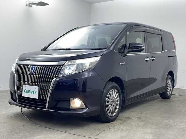 トヨタ エスクァイア ハイブリッド Gi 兵庫県 2016(平28)年 9.2万km スパークリングブラックパールクリスタルシャイン ・純正９インチナビ（NSZT-Y66T）/CD/DVD/TV/SD/BT/USB/HDMI/・純正12.1型フリップダウンモニター（V12T-R66C）/・ビルトインETC/・バックカメラ/・ビルトインETC/・両側パワースライドドア/・Toyota Safety Sense C/プリクラッシュセーフティ/レーンディパチャーアラート/オートマチックハイビーム/・クルーズコントロール/・先行車発進告知/・合成皮革シート/・前席シートヒーター/・ＬＥＤヘッドライト/・フォグランプ/・スマートキー/・プッシュスタート