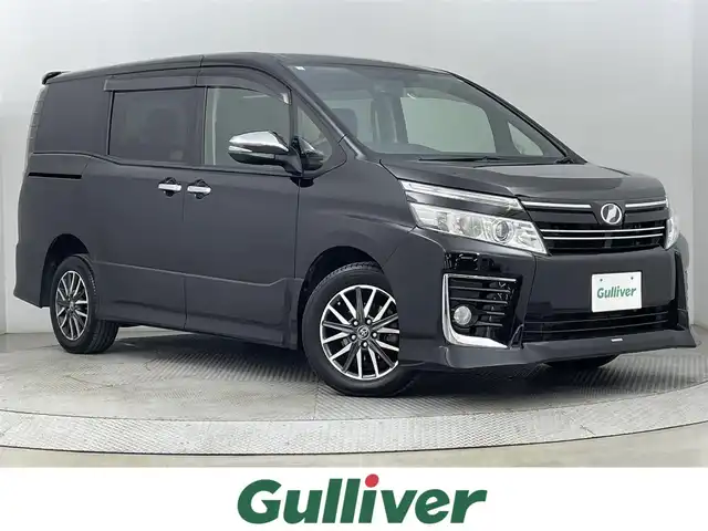 トヨタ ヴォクシー ZS 煌 道央・札幌 2015(平27)年 11.5万km ブラック ・4WD/・社外メモリーナビ/　CD/DVD/SD/BT/フルセグ/・アルパイン11.4型フリップダウンモニター/・純正エンジンスターター/・フルセグTV/・両側パワースライドドア/・バックカメラ/・オートライト/・ビルトインETC/・LEDヘッドライト/・プッシュスタートボタン/・MTモード付AT/・寒冷地仕様/・アイドリングストップ/・スペアキー/・WAC/・Bluetooth接続/・CDチェンジャー/・USB入力端子/・社外ドライビングレコーダー（前方のみ）/・純正フロアマット/・横滑り防止機能/・盗難防止装置/・ABS/・フロントフォグランプ/・ドアミラーウインカー/・ドアバイザー/・ステアリングリモコン/・シートカバー