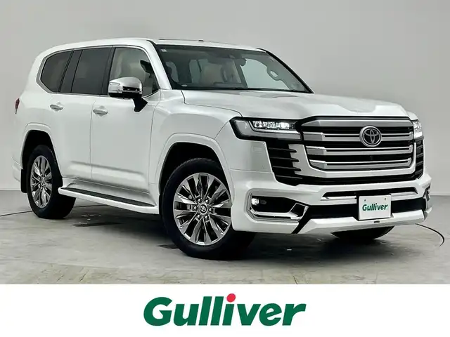 トヨタ ランドクルーザー ZX 愛知県 2024(令6)年 0.9万km プレシャスホワイトパール 純正12.3型メモリナビ/フルセグTV/BT/CD/DVD/USB/AppleCarPlay/AndroidAuto/パノラミックビューモニター/電動ムーンルーフ/JBLサウンド/モデリスタエアロ/本革シート/シートヒーター＆ベンチレーション　D/N/2列目席/パワーシート　D/N席/COOLBOX/360°ドライブレコーダー/ビルトインETC2.0/HUD/トヨタセーフティセンス/PCS/LTA/LDA/BSM/PKSB/ACC/RCTA/RCD/RSA/AHB/先行車発進告知/パワーバックドア/AC100V/サイドステップ/3列目電動格納シート/革・杢目調コンビステアリング/ステアリングスイッチ/ステアリングヒーター/スマートキー＆プッシュスタート/DAC（ダウンヒルアシスト/MTS（マルチテレインセレクト/電動パーキング/オートブレーキホールド/3眼LEDオートライト/フォグランプ/シーケンシャルターンランプ/サイドステップ/充電用USBポート/純正20インチAW/ラバーマット/スペアタイヤ