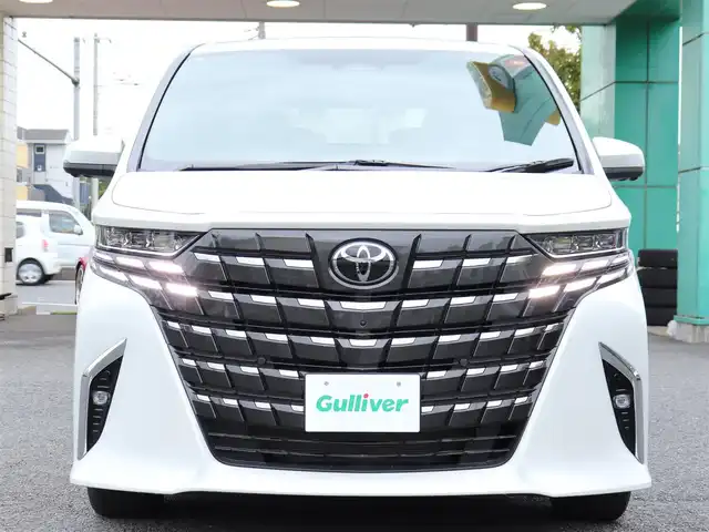 トヨタ アルファードハイブリット Z 神奈川県 2025(令7)年 0.1千km ホワイトパールクリスタルシャイン ユニバーサルステップ/左右独立ムーンルーフ/パワーサンシェード/デジタルインナーミラー/ワンオーナー/JBLスピーカー/純正メモリナビ/フルセグテレビ/バックカメラ/全周囲カメラ/ブラインドスポットモニター/ETC2.0/おくだけ充電/100V電源/革巻きコンビステアリングホイール/電動チルトテレスコピックステリング/ステアリングスイッチ/ステアリングヒーター/シートヒーター/エアーシート/225/60R18タイヤ/18インチ5本トリプルスポークスーパークロームメタリック塗装AW/快適温熱シート/マイコンプリセットドライビングポジションシステム(運転席)/助手席肩口パワーシートスイッチ/エグゼクティブパワーシート(2列目)/ウィンカーミラー/クルーズコントロール(追従走行あり)/ドアバイザー/プッシュスタート/パワーバックドア/両側パワースライドドア/純正LEDヘッドライト/純正フロアマット/コーナーセンサー前後