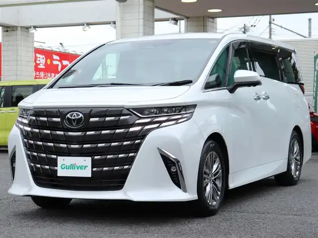 トヨタ アルファードハイブリット Z 神奈川県 2025(令7)年 0.1千km ホワイトパールクリスタルシャイン ユニバーサルステップ/左右独立ムーンルーフ/パワーサンシェード/デジタルインナーミラー/ワンオーナー/JBLスピーカー/純正メモリナビ/フルセグテレビ/バックカメラ/全周囲カメラ/ブラインドスポットモニター/ETC2.0/おくだけ充電/100V電源/革巻きコンビステアリングホイール/電動チルトテレスコピックステリング/ステアリングスイッチ/ステアリングヒーター/シートヒーター/エアーシート/225/60R18タイヤ/18インチ5本トリプルスポークスーパークロームメタリック塗装AW/快適温熱シート/マイコンプリセットドライビングポジションシステム(運転席)/助手席肩口パワーシートスイッチ/エグゼクティブパワーシート(2列目)/ウィンカーミラー/クルーズコントロール(追従走行あり)/ドアバイザー/プッシュスタート/パワーバックドア/両側パワースライドドア/純正LEDヘッドライト/純正フロアマット/コーナーセンサー前後