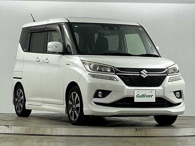 スズキ ソリオ バンディット HV MV 愛知県 2018(平30)年 6.8万km ピュアホワイトP 禁煙車/純正7インチナビ/（CD/DVD/Bluetooth/フルセグTV）/バックカメラ/スズキセーフティサポート/・衝突軽減ブレーキ/・レーダークルーズコントロール/・レーンキープアシスト/・オートマチックハイビーム/・標識認識機能/・ふらつき警報機能/・先行車発進お知らせ機能/ETC/ドライブレコーダー/両側パワースライドドア/パドルシフト/LEDヘッドライト/フロントフォグランプ/オートライト/スマートキー/プッシュスタート/純正15インチアルミホイール/スタッドレスタイヤ積載有15インチ