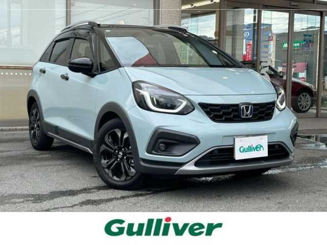 ホンダ フィット e:HEVクロスター 大阪府 2023(令5)年 0.6万km フィヨルドミストパール ワンオーナー/純正8インチナビ(BT/CD)/レーダークルーズコントロール/フロントカメラ/バックモニター/レーンキープアシスト/衝突被害軽減システム/横滑り防止装置/前後コーナーセンサー/ハーフレザーシート/純正フロアマット/純正１６インチAW/ルーフレール/ETC/取扱説明書/保証書/スペアキー　あり