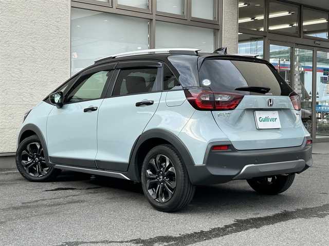 ホンダ フィット e:HEVクロスター 大阪府 2023(令5)年 0.6万km フィヨルドミストパール ワンオーナー/純正8インチナビ(BT/CD)/レーダークルーズコントロール/フロントカメラ/バックモニター/レーンキープアシスト/衝突被害軽減システム/横滑り防止装置/前後コーナーセンサー/ハーフレザーシート/純正フロアマット/純正１６インチAW/ルーフレール/ETC/取扱説明書/保証書/スペアキー　あり