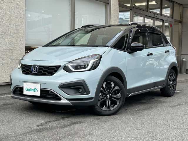 ホンダ フィット e:HEVクロスター 大阪府 2023(令5)年 0.6万km フィヨルドミストパール ワンオーナー/純正8インチナビ(BT/CD)/レーダークルーズコントロール/フロントカメラ/バックモニター/レーンキープアシスト/衝突被害軽減システム/横滑り防止装置/前後コーナーセンサー/ハーフレザーシート/純正フロアマット/純正１６インチAW/ルーフレール/ETC/取扱説明書/保証書/スペアキー　あり