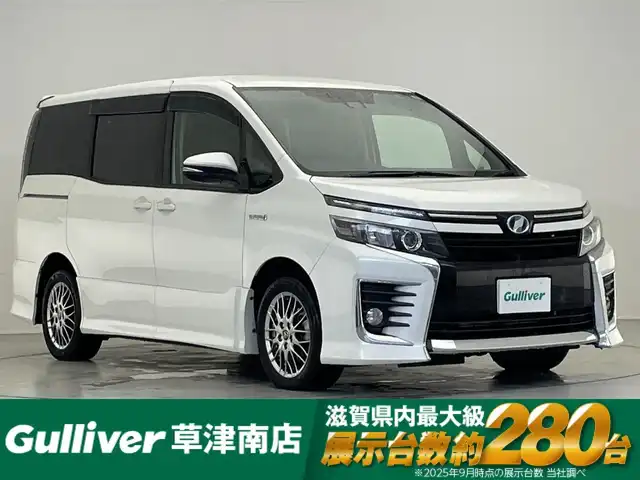 トヨタ ヴォクシー ハイブリッド ZS 滋賀県 2016(平28)年 6.6万km ホワイトパールクリスタルシャイン 純正10インチナビ/Bluetooth/CD/DVD/フルセグTV/フリップダウンモニター/バックカメラ/片側パワースライドドア/デジタルインナーミラー/LEDヘッドライト/オートハイビーム/純正16インチアルミホイール/ドライブレコーダー/ETC