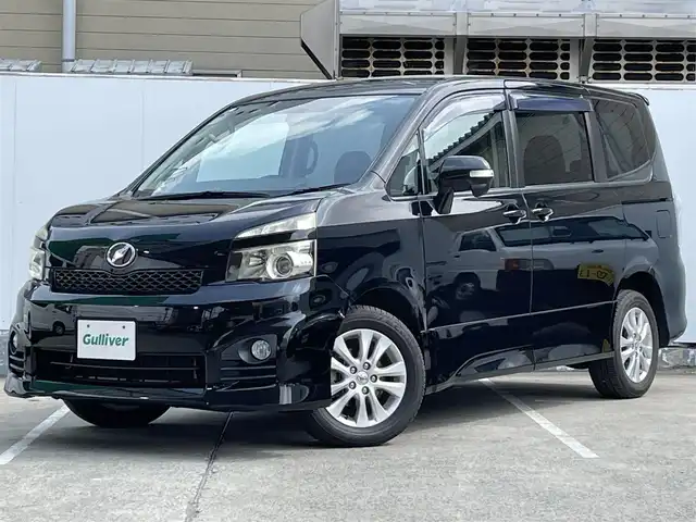 トヨタ ヴォクシー ZS 青森県 2010(平22)年 10.8万km ブラック AIS評価3.5点/4WD/ワンオーナー/純正メモリナビ/[BT/AM/FM/DVD/CD/AUX]/フルセグテレビ/バックカメラ/WAC/寒冷地仕様/両側パワースライドドア/純正AW(16インチ)/純正フロアマット/社外ドライブレコーダー/保証書/取扱説明書