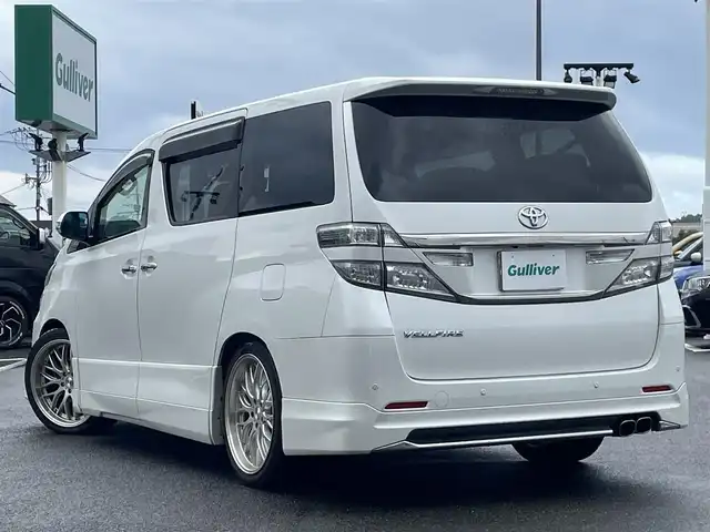 トヨタ ヴェルファイア 2．4Z Gエディション 長崎県 2013(平25)年 9.6万km パール 純正メモリナビ/CD/DVD/BT/フルセグTV/バックカメラ/純正フリップダウンモニター/両側パワースライドドア/クルーズコントロール/革調シートカバー/前席パワーシート/D席メモリーシート/モデリスタエアロ/パワーバックドア/ドライブレコーダー前後/社外レーダー/室内灯LEDヘッドライト/LEDヘッドライト/純正AW積み込み