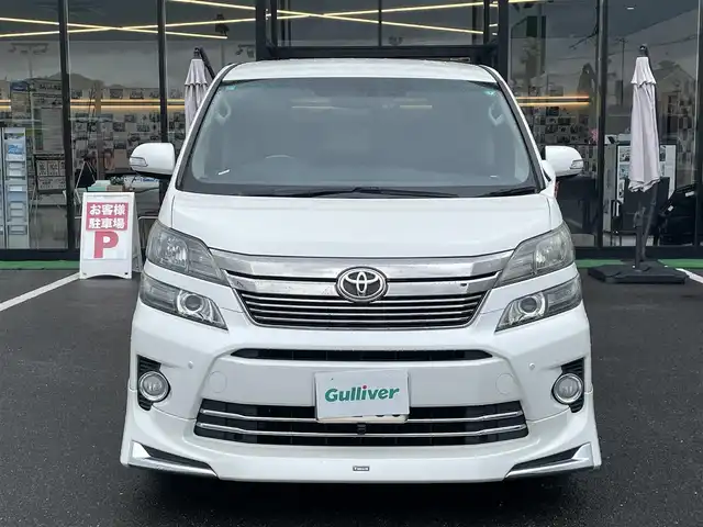トヨタ ヴェルファイア 2．4Z Gエディション 長崎県 2013(平25)年 9.6万km パール 純正メモリナビ/CD/DVD/BT/フルセグTV/バックカメラ/純正フリップダウンモニター/両側パワースライドドア/クルーズコントロール/革調シートカバー/前席パワーシート/D席メモリーシート/モデリスタエアロ/パワーバックドア/ドライブレコーダー前後/社外レーダー/室内灯LEDヘッドライト/LEDヘッドライト/純正AW積み込み