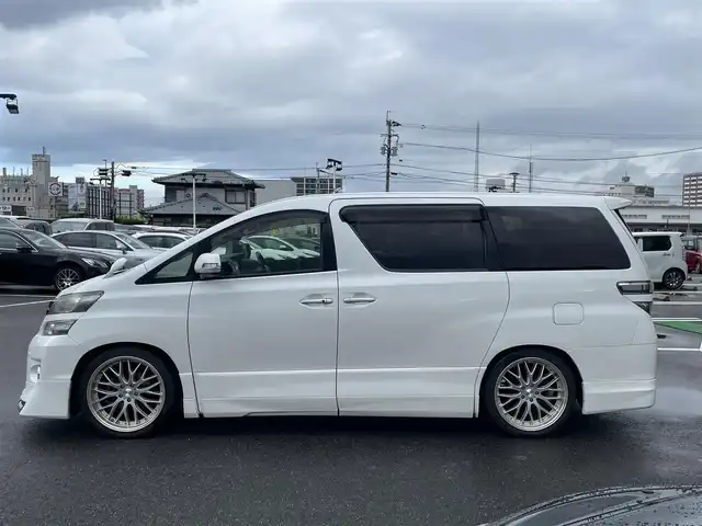 トヨタ ヴェルファイア 2．4Z Gエディション 長崎県 2013(平25)年 9.6万km パール 純正メモリナビ/CD/DVD/BT/フルセグTV/バックカメラ/純正フリップダウンモニター/両側パワースライドドア/クルーズコントロール/革調シートカバー/前席パワーシート/D席メモリーシート/モデリスタエアロ/パワーバックドア/ドライブレコーダー前後/社外レーダー/室内灯LEDヘッドライト/LEDヘッドライト/純正AW積み込み