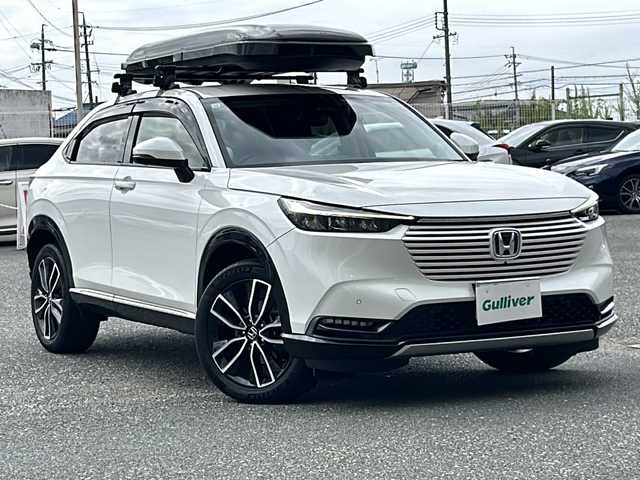 ホンダ ヴェゼル ハイブリッド e:HEV Z 愛知県 2021(令3)年 9.6万km プラチナホワイトパール ワンオーナー/純正カーナビ/TVフルセグ/BT/全方位カメラ/純正フロアマット/置くだけ充電/クルーズコントロール/ハンドルヒーター/シートヒーター(Ｄ・Ｎ)/ハーフレザーシート/革巻きステアリング/パワーバッグドア/ミラーウィンカー/純正ドラレコ(前後)/コーナーセンサー(前後)/社外ルーフレール/ルーフボックス/社外アルミホイールあり/スタッドレスあり/ドアバイザー/フォグランプ/エアバッグW＋サイド＋カーテン/プッシュスタート/ETC2.0/取扱説明書/保証書/記録簿