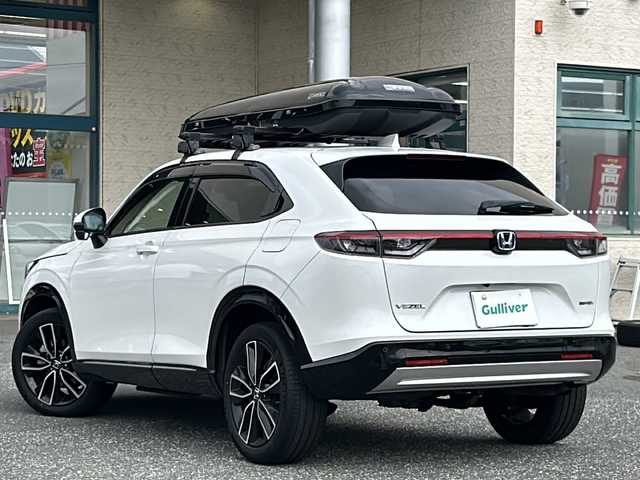 ホンダ ヴェゼル ハイブリッド e:HEV Z 愛知県 2021(令3)年 9.6万km プラチナホワイトパール ワンオーナー/純正カーナビ/TVフルセグ/BT/全方位カメラ/純正フロアマット/置くだけ充電/クルーズコントロール/ハンドルヒーター/シートヒーター(Ｄ・Ｎ)/ハーフレザーシート/革巻きステアリング/パワーバッグドア/ミラーウィンカー/純正ドラレコ(前後)/コーナーセンサー(前後)/社外ルーフレール/ルーフボックス/社外アルミホイールあり/スタッドレスあり/ドアバイザー/フォグランプ/エアバッグW＋サイド＋カーテン/プッシュスタート/ETC2.0/取扱説明書/保証書/記録簿