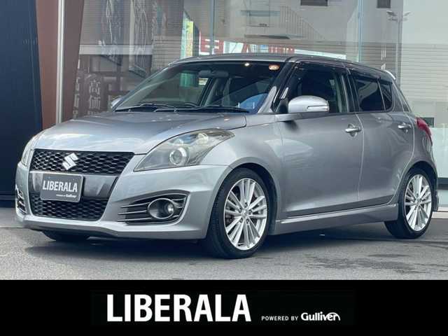 スズキ スイフト スポーツ 鹿児島県 2012(平24)年 8.4万km プレミアムシルバーメタリック 6速マニュアル車/社外ナビ(CN-MW240D)/社外CD/DVD再生可/社外フルセグTV/クルーズコントロール/オートエアコン/オートライト/社外マフラー/キセノンヘッドライト/電動格納ミラー/純正フォグ/ドアバイザー/保証書/取扱説明書/スペアキー1本(スマートキー)