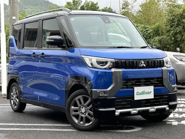 三菱 デリカミニ T プレミアム 長崎県 2023(令5)年 1.1万km 青Ⅱ ・プッシュスタート/・ディスプレイオーディオ（AM/FM/アンドロイドオート/アップルカープレイ）/・クルーズコントロール（追従有）/・両側パワースライドドア/・ダウンヒルアシストコントロール/・スマホ非接触充電/・ヒートシーター（D/N）/・ブルートゥース/・ハンドルヒーター/・オートライト/・オートハイビーム/・パーキングアシスト/・オートホールド/・ハンドルスイッチ/・パドルシフト/・デジタルインナーミラー