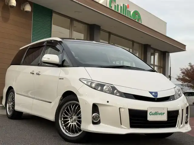トヨタ エスティマ ハイブリッド アエラス レザーパッケージ 香川県 2012(平24)年 7.5万km ホワイトパールクリスタルシャイン 9インチサイバーナビ/フルセグ/CD/DVD/BT/13.3インチフリップダウンモニター/ダブルサンルーフ/バックカメラ/社外18インチアルミ/ブラックレザーシート/パワーシート/前席シートヒーター/キセノンヘッドライト/両側パワースライドドア/パワーバックドア/ローダウン/社外スピーカー/社外アンプ/オーディオネットワーク/前後ドライブレコーダー/ETC