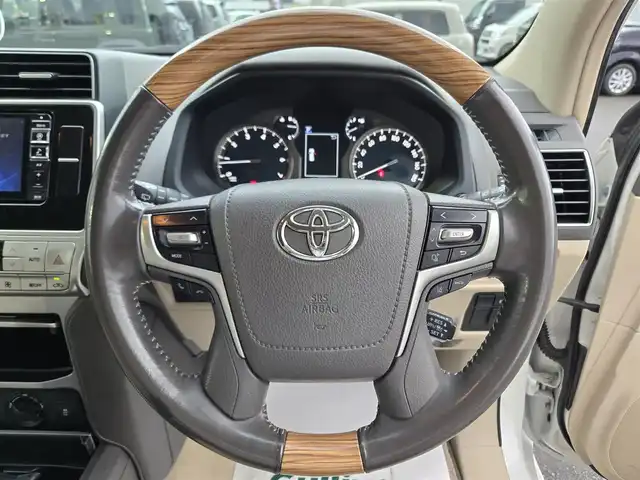 トヨタ ランドクルーザー プラド TX Lパッケージ 鹿児島県 2018(平30)年 5万km ホワイトパールクリスタルシャイン 前後モデリスタエアロ　/ムーンルーフ　/ヒッチメンバー　/ヒッチキャリア　/ラゲージプロテクター　/ＡＬＰＩＮＥナビ　/ウッドコンビステア　/純正サイドステップカバー　/ルーフレール　/純正アルミホイール（１９インチ）/前後コーナーセンサー/Bluetoothオーディオ/フルセグテレビ/D+N席シートヒーター/D+N席シートベンチレーション/D+N席パワーシート/電動格納サードシート/社外フロアマット/プッシュスタート/スマートキー/横滑り防止装置/レーンキープアシスト