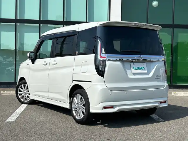 スズキ ソリオ HV MZ 和歌山県 2023(令5)年 2.3万km ピュアホワイトP 純正9インチナビ/フルセグTV/Bluetooth/CD/DVD/USB/アラウンドビューモニター/ETC/衝突軽減カメラ/車線逸脱防止機能/コーナーセンサー/レーダークルーズコントロール/HUD（ヘッドアップディスプレイ）/両側パワースライドドア/革巻きステアリング/ステアリングスイッチ/前席シートヒーター/リアドアサンシェード/後席サーキュレーター/LEDヘッドライト/フォグランプ/オートライト/電動格納ミラー/フルオートエアコン/アイドリングストップ/社外15インチAW/ドアバイザー/純正フロアマット/プッシュスタート/スマートキー