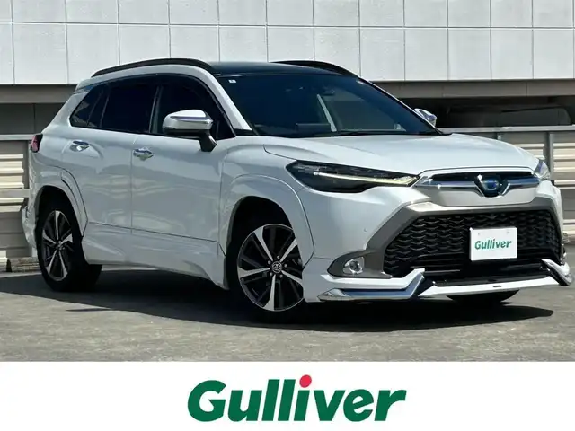 トヨタ カローラ クロス ハイブリッド Z 静岡県 2022(令4)年 2.5万km プラチナホワイトパールマイカ トヨタセーフティセンス/純正9型ディスプレイオーディオ/フルセグTV/パノラマビューモニター/パノラマルーフ/モデリスタエアロFSR/モデリスタカラードフェンダー/モデリスタバックドアガーニッシュ/モデリスタフロントグリルガーニッシュ/モデリスタミラーガーニッシュ/モデリスタドアバンドルガーニッシュ/1500W電/前席シートヒーター/ハンドルヒーター/PKSB/BSM/電動リアゲート/ドラレコ/ハーフレザーシート/純正フロアマット/ルーフレール/レーダークルーズ