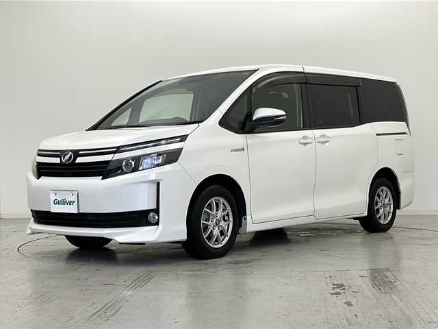 トヨタ ヴォクシー ハイブリッド V 宮城県 2014(平26)年 7.4万km ホワイトパールクリスタルシャイン 禁煙車/純正フリップダウンモニター/純正9インチナビ/・CD.DVD.SD.BT/フルセグTVバックモニター/両側パワースライドドア/クルーズコントロール/前席シートヒーター/LEDヘッドライト/フォグランプ/ビルトインETC/置くだけ充電/ステアリングスイッチ/アイドリングストップ/横滑り防止装置/純正フロアマット/社外15インチアルミホイール